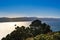 View over Wellington harbour as a small cargo ship heads away in sunset light