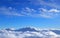 View over white cumulus clouds in an endless space of blue sky