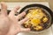 View of overcooked, burnt eggs, omelet in an old cast iron frying pan