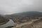 View overview from the city of Vardzia city of Queen Tamara Georgia high mountain and river at the foot in cloudy weather