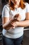 View of overweight girl checking pulse with hand