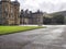 View of the Palace of Holyroodhouse from the outside under the cloudy sky in Edinburgh