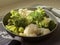 View of the pan with fresh defrosted vegetables and kitchen spatula