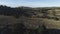 View of panorama from land of hilly valley. Shot. Top view of stone hills and horizon with blue sky. White observatories