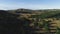 View of panorama from land of hilly valley. Shot. Top view of stone hills and horizon with blue sky. White observatories