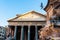 View of pantheon in rome with pigeons flying in front