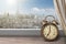 View of Paris and Eiffel tower from window with alarm clock