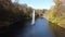 View park, fountain, lake, trees, large stones on banks on sunny autumn day