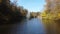 View park, fountain, lake, trees, large stones on banks on sunny autumn day