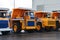 View of the parking lot of an exhibition of large career heavy dump trucks at the automobile plant Belaz