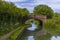 A view past a bridge towards a flight of lock gates on the Oxford Canal beside the village of Napton, Warwickshire