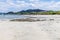 A view past rocky outcrops along the beach towards the town at Tamarindo in Costa Rica