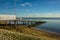 A view past a slipway towards the longest pleasure pier in the world in the distance at Southend-on-Sea, UK