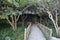 View of path with wooden fence and cute house in the jungle