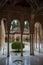 View at the Patio at the Lions, twelve marble lions fountain on Palace of the Lions or Harem, Alhambra citadel, tourist people