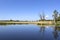 View of a peaceful river landscape. Everything is reflected in the calm water