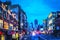 View of pedestrians and traffic along Canal Street in Lower Manhattan at dusk.