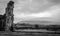 A view of Pendle Hill with a ruin and sheep. black and white