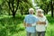 View pensioner hugging senior wife in green park