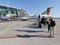 View of people queuing on the runway outside to get a commercial plane, maintenance of aircraft at Lisbon airport