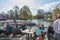 View at people seat on terrace table bar on river Cam banks, on Cambridge city Downtown, with the typical gondola boats for