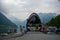 View of people sitting by Fjord sea near the port of the tourist ferry in Geiranger village, Norway