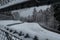 The view through a photo hole of the snow-covered Nordschleife race track in the Eifel