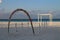 View of a photo zone on the shores of the Indian Ocean with a white wooden frame, an arch of flowers and a picturesque driftwood