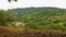 View of a picturesque rural village with quaint houses on the hills surrounded by lush trees