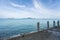 View from pier on a beautiful crystal sea, blue sky with clouds and green islands