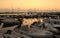 View of the pier with yachts, boats, ships in the evening, at sunset. Vlychada, Santorini. Greece.