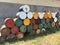 View of pile of empty big rusty fuel metal barrels outdoors near