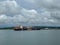 A view of Pilot boats alongside their next ship to guide into the Panama Canal and ships anchored waiting to enter the canal