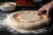 view of pizza dough being rolled out into perfect circle, ready for toppings