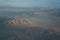 View from plane during flight over California mountains in sunset