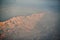 View from plane during flight over California mountains in sunset