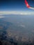 View from the plane window to the river, rocks and white clouds