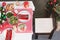 View of plates, salad, asparagus, wine glass, candles and gift on table in christmas