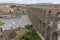 View at the Plaza Oriental and Towering Roman aqueduct & grand landmark monument of Segovia, on Segovia downtown