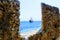 View of a pleasure sailing ship for sea excursions through the loophole of the fortress wall Antalya, Turkey