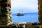 View of a pleasure sailing ship for sea excursions through the loophole of the fortress wall Antalya, Turkey