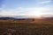 View of a plowed fertile field before sunset