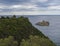 View point with cross and cllifs, trees and green hill at Paleokastritsa bay, summer cloudy sky, Corfu, Kerkyra, Greece