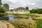 View of pond and wooden house museum of the 19th century in Dmitrov. Russia