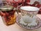 View of porcelain cup and honey with nuts on the table