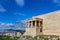 View of the Porch of the Caryatids on the Erechtheion temple on the Athens Accropolis with a view of Athens and a mountains in the