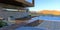 View from the porch of a wonderful country house on a magnificent mountain landscape. Blue sun loungers by the pool. Terrace board