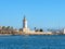 View of the port of Malaga. `Muelle Uno` shopping mall,Malagueta buildings and La Farola lighthouse