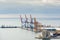 View of the port of Malaga, Spain with a container ship on the pier and several cranes