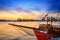 View of the port of Varna at sunset, moored sailing ship and harbor cranes in the background